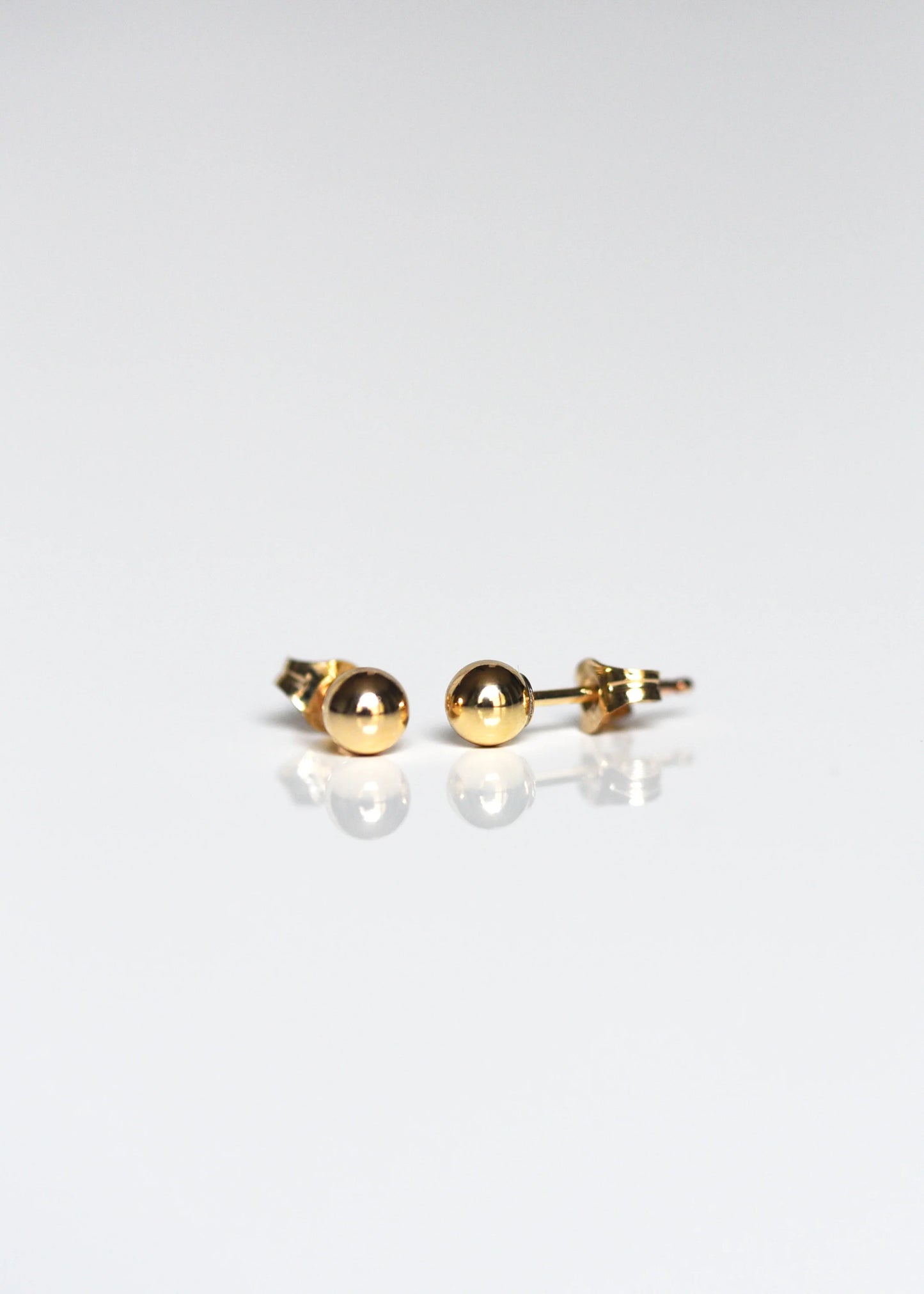 Tiny gold bead studs.